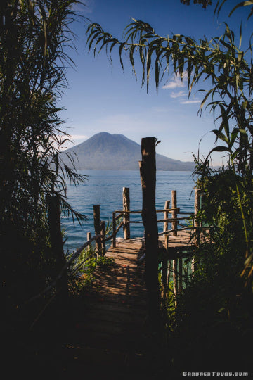 A breathtaking view of a volcano over Lake Atitlan in Guatemala, representing the diverse boutique destinations offered by Gardner Tours.