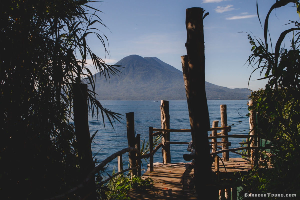 A breathtaking view of a volcano over Lake Atitlan in Guatemala, representing the diverse boutique destinations offered by Gardner Tours.