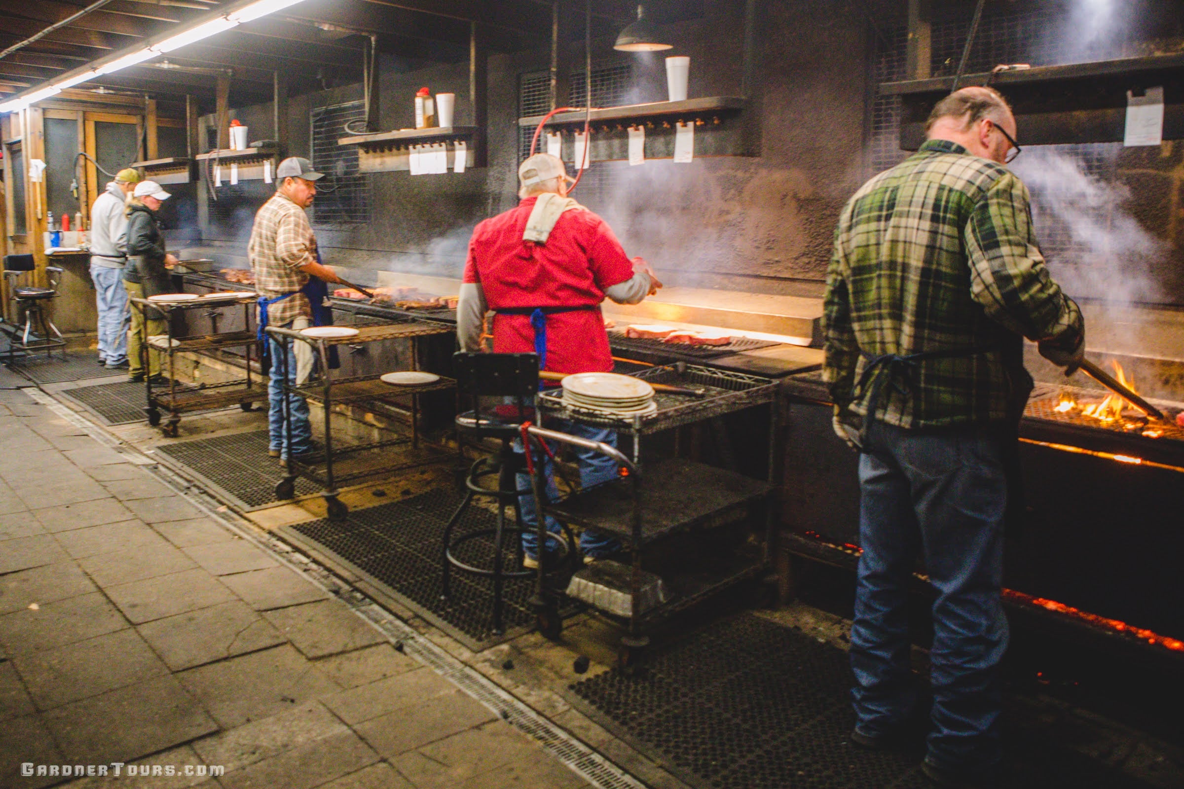 A line of cooks cook steaks and chicken and pork at Leona General Store in Leona, Texas.