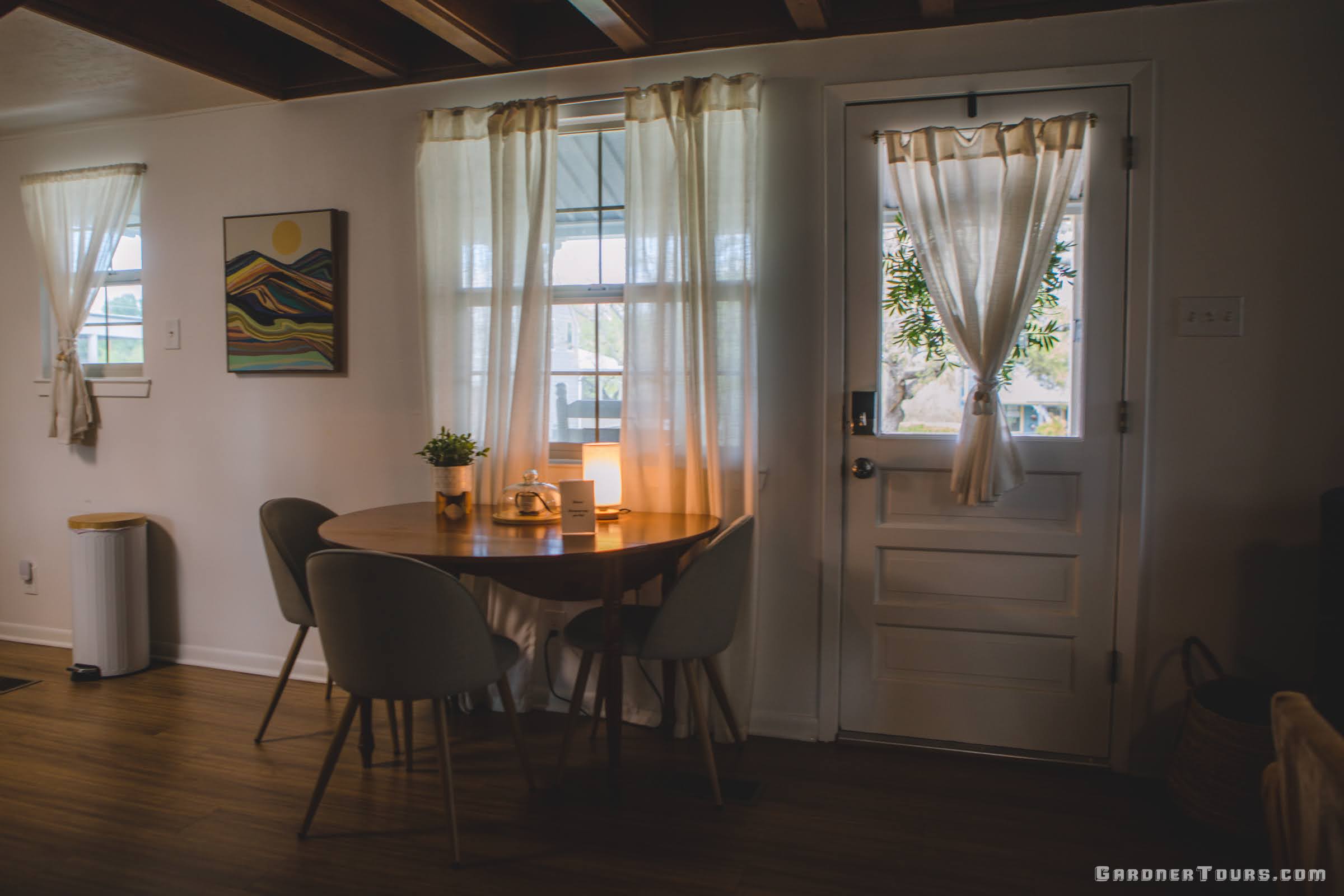 A cute farmhouse dining room with warm lighting at a bnb in Fredericksburg, Texas.