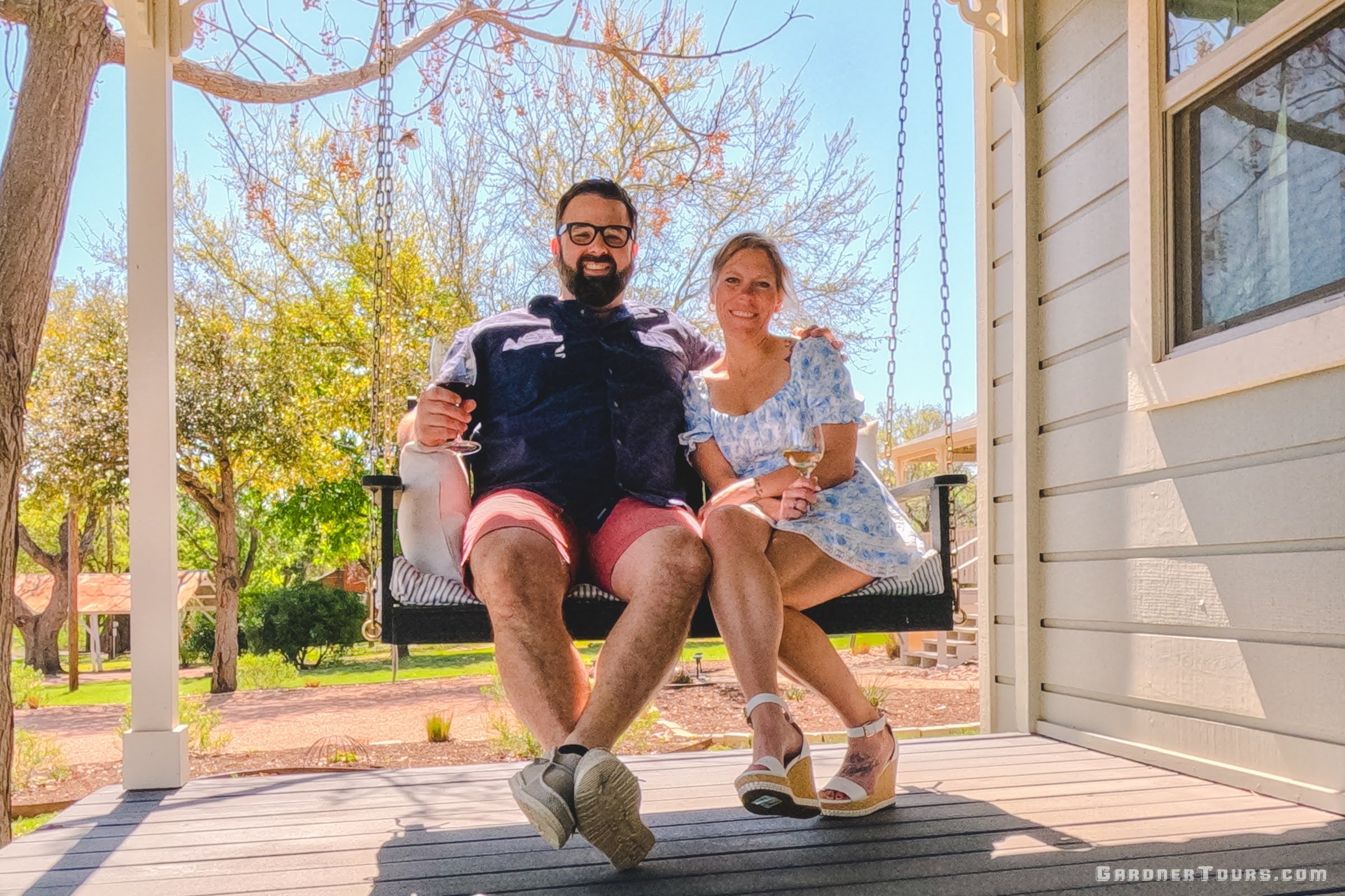 Colby and Josie Gardner, a young couple, enjoy a glass of wine on the front porch swing of their bnb in Fredericksburg, Texas.