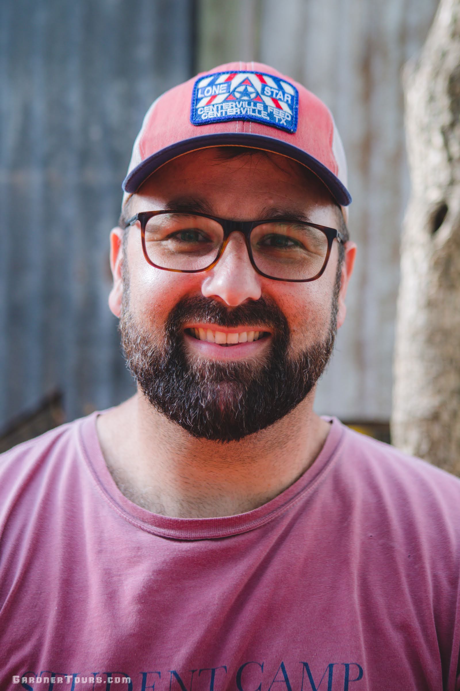 Lead guide and host Colby Gardner smiling in a Centerville Lone Star hat on the hunting ranch property.