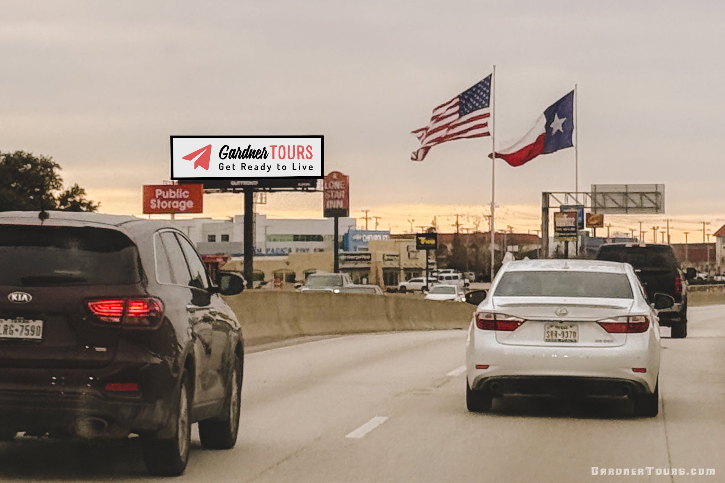 Three cars drive down the freeway in Texas with a USA flag, a Texas flag, and a Gardner Tours billboard in the distance.