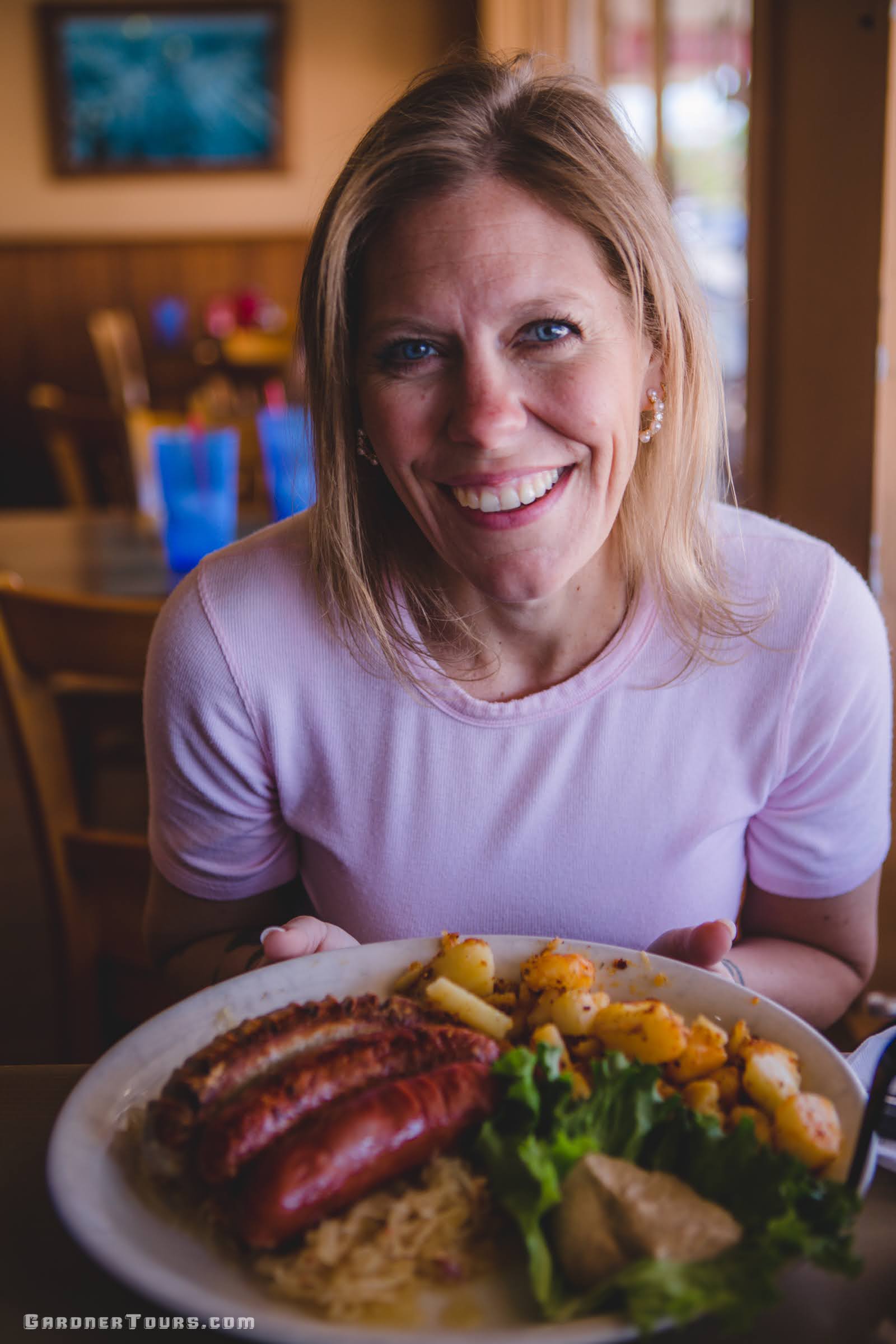 Josie Gardner preparing to eat a big breakfast plate of German food and German sausage at the Old German Bakery Restaurant in Fredericksburg, Texas.