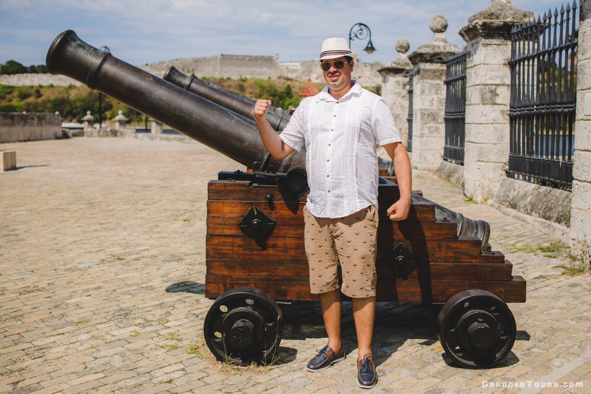 Man in White Guayabera Flexing with Canons at the Castle of the Royal Force in Old Havana, Cuba