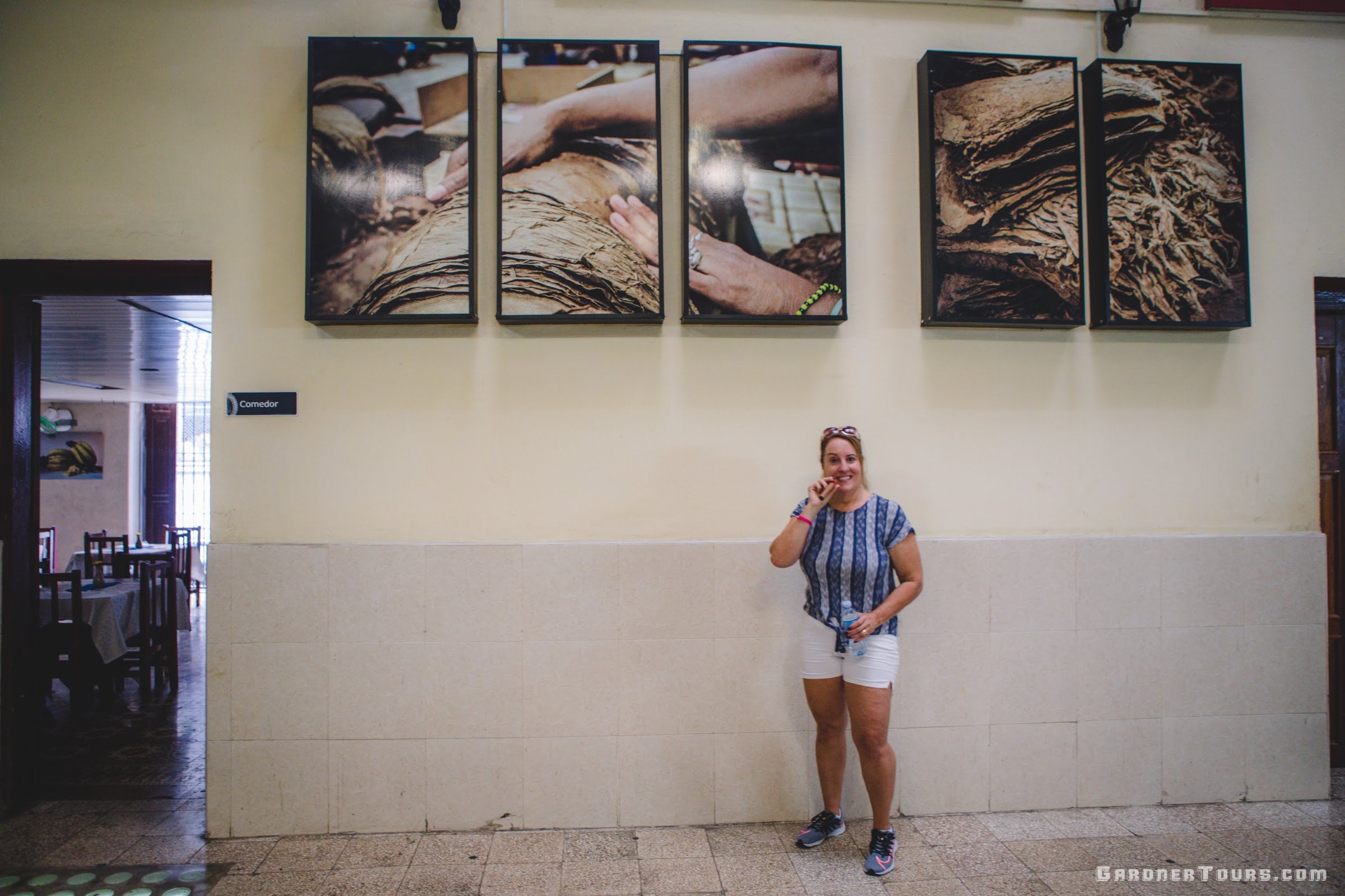 Woman Taking Picture In Front Of Pictures At H. Upmann Cigar Factory