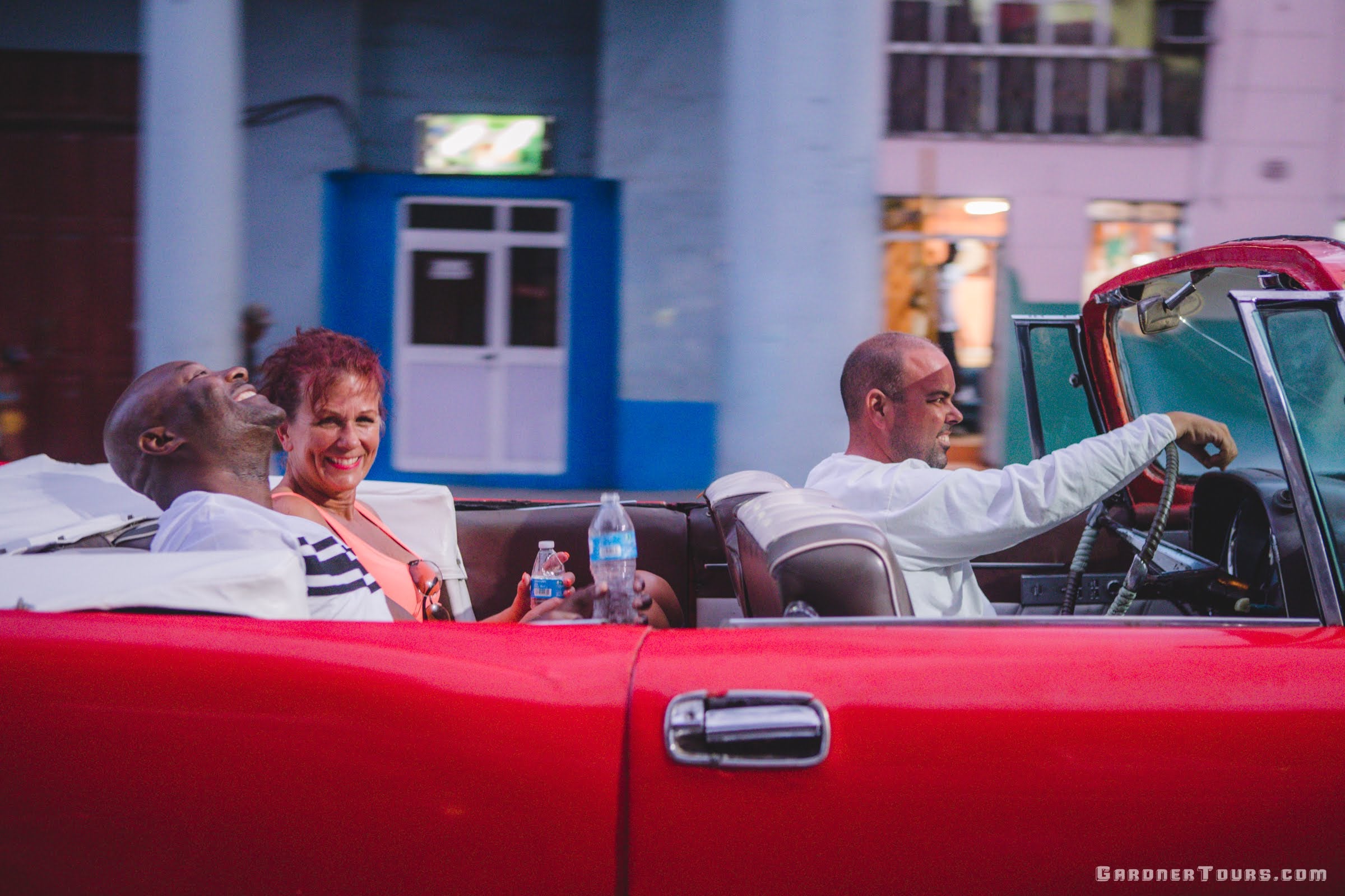 Black Man and White Woman Couple Loving their Convertible Classic Car Tour in Havana, Cuba