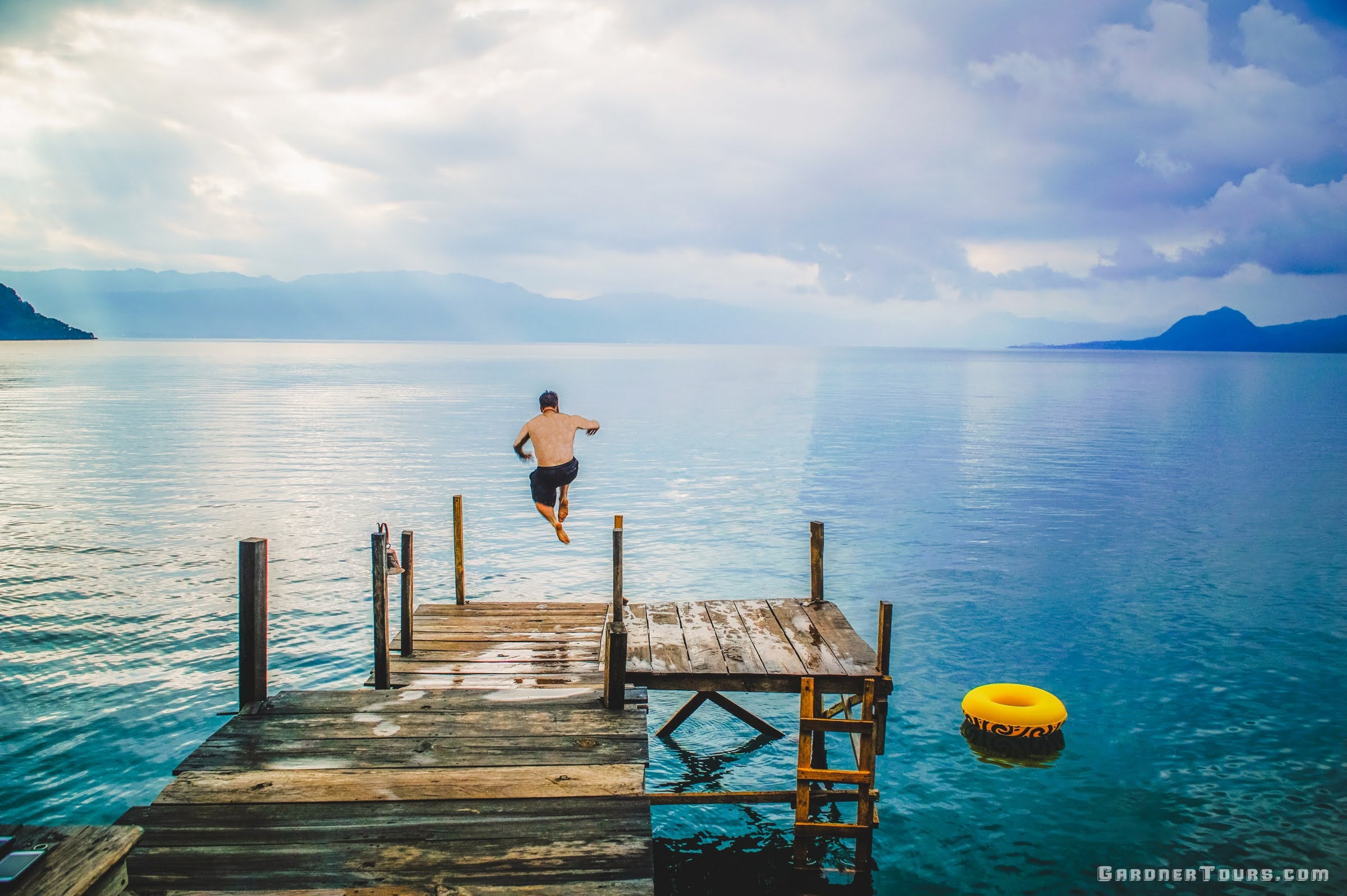 Man Diving into Lake Atitlan from a Dock a Maya Luna at Lake Atitlan in Guatemala