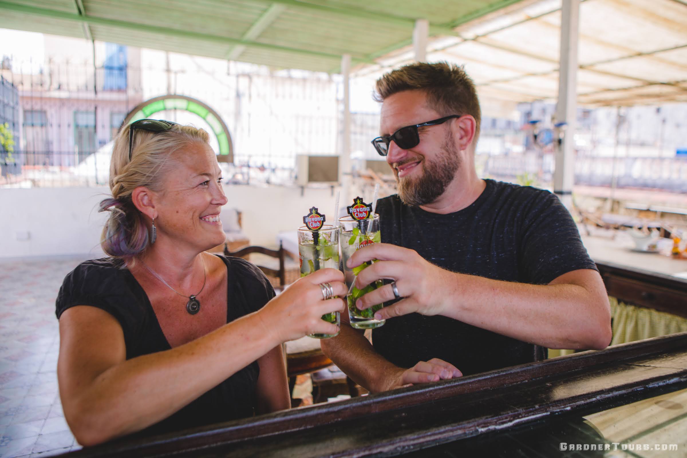 Couple Cheers with Cuban Mojitos at a Private Rooftop Bar in Havana, Cuba