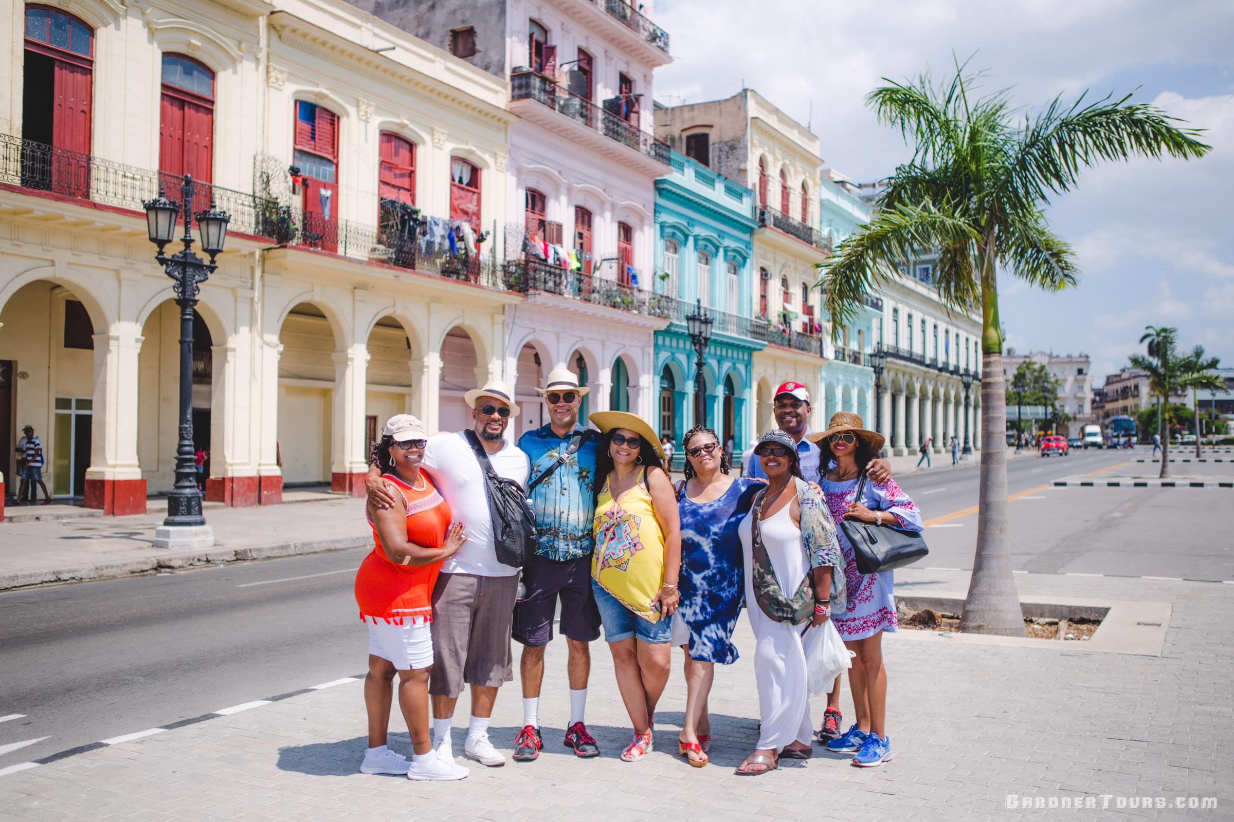Group of Family in front of Cuban Capitol at KM Zero in Havana Cuba with Colorful Buildings