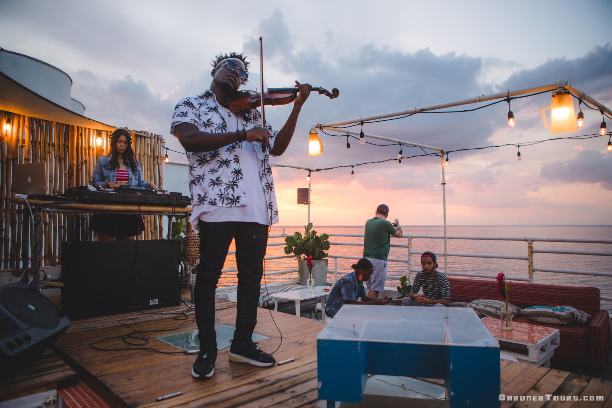 Man playing Violin and woman playing piano during Live Jazz Night at Malecon 663 during Sunset in Havana Cuba