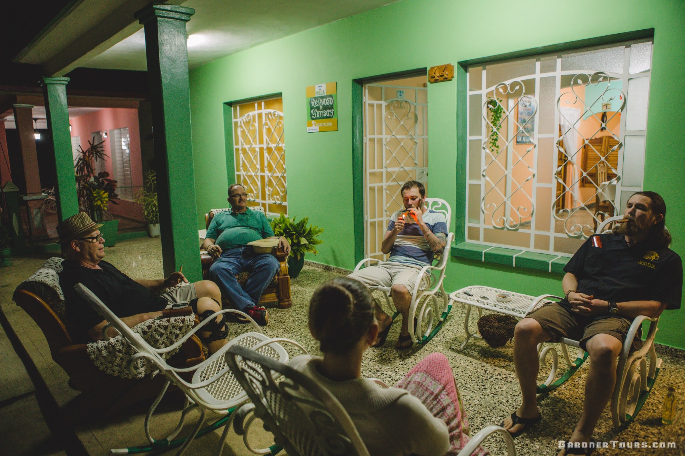 Group of Friends Smoking Cigars on Front Porch in Vinales, Cuba