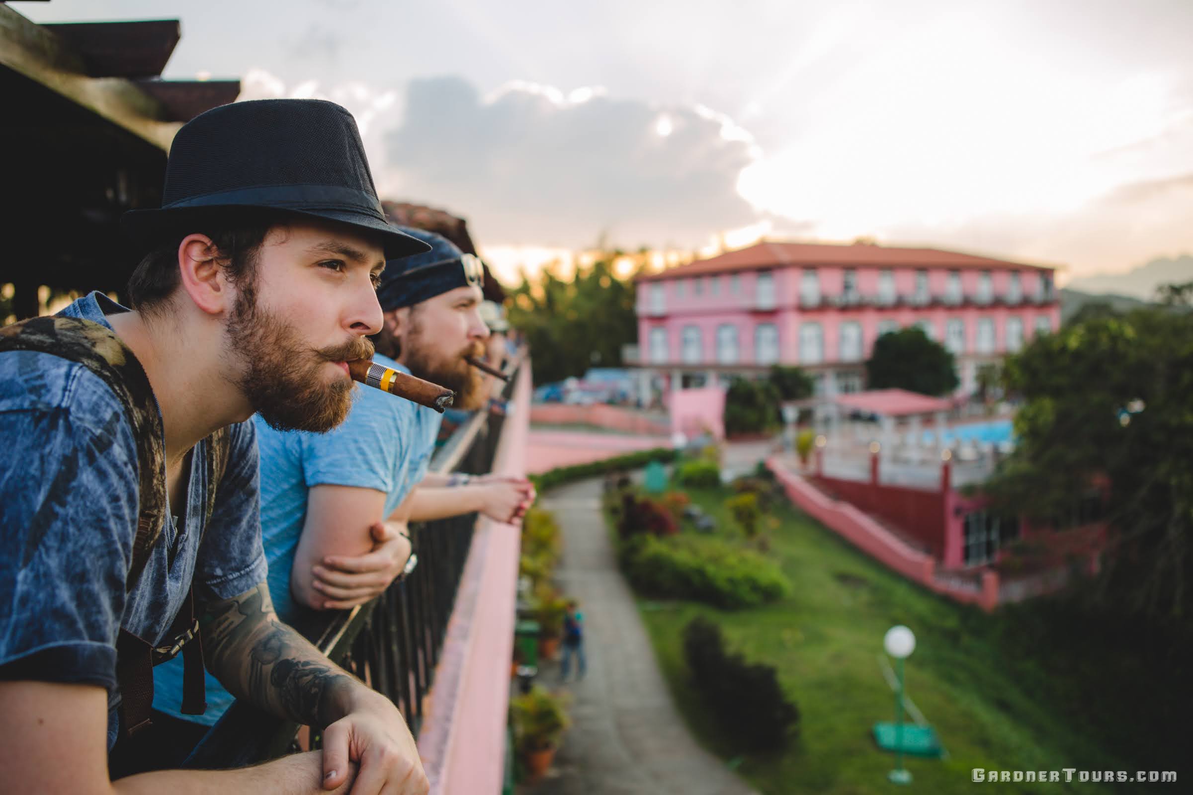 Two friends smoking cigars and enjoying the Viewpoint at Los Jazmines Hotel in Vinales, Cuba