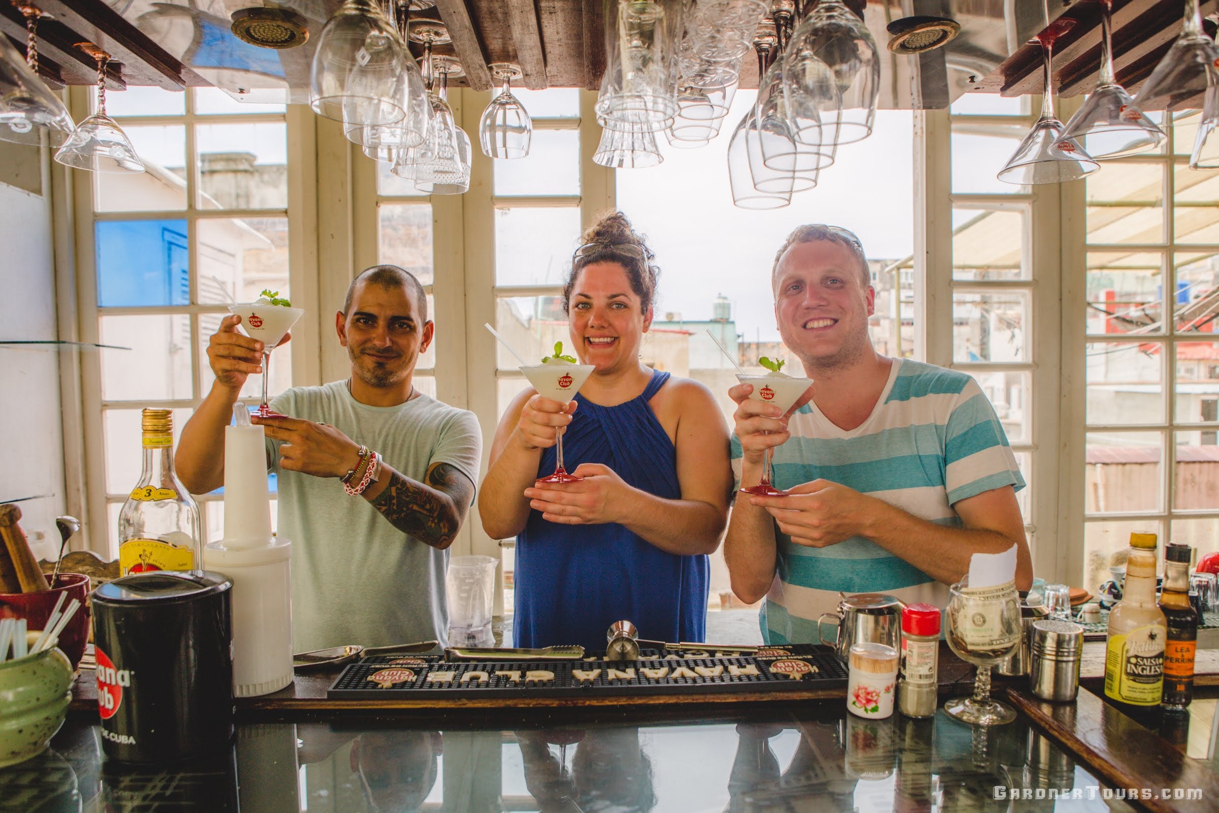 Couple making Cuban Cocktails during a Lesson with a Bartender in Havana, Cuba
